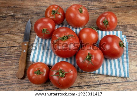 several tomatoes on a wooden table