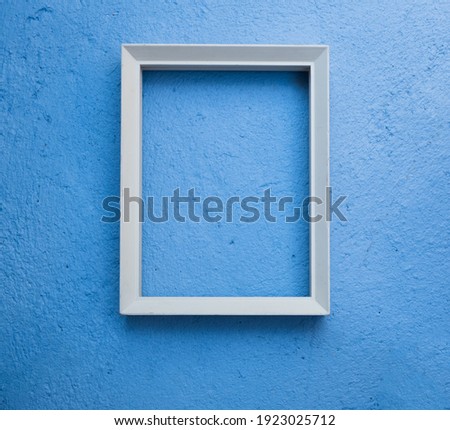 Vintage white picture rame mock up over blue cement  background,flat lay