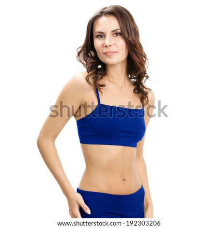 Young cheerful smiling woman in sports wear, isolated over white background