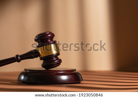 Judge gavel on a homogeneous background Justice and injustice, law Royalty-Free Stock Photo #1923050846