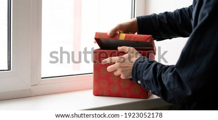 person open the gifted present box and check whats inside, surprise on the holidays