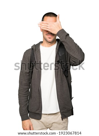 Student covering his eyes with his hands