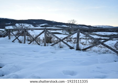 Snowy Hills Over the Fence 