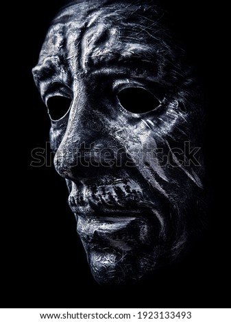 Creepy man head mask on black background
