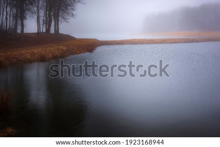 Tranquil Foggy Landscape of Pond and Tree Hills on Cape Cod, Massachusetts 