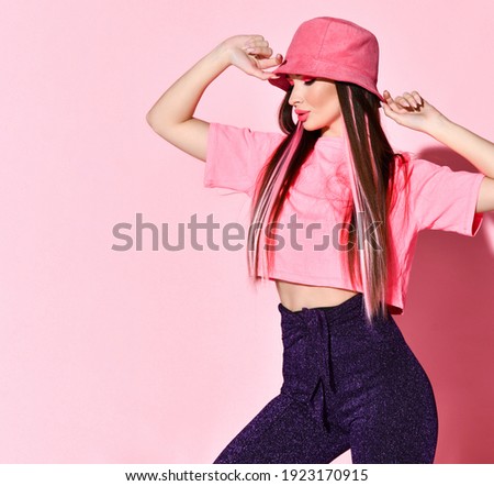 Stylish beauty studio portrait of teenager girl model isolated on pink background. Happy charming young woman with joyful facial expression . Teenage and youth. Summer teen fashion