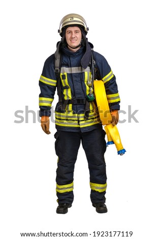 Young brave man in uniform and hardhat of firefighter holds fire hose in hand and looking at camera isolated on white background