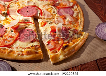 Pizza with Ham, Salami, Tomatoes and Mozzarella Cheese