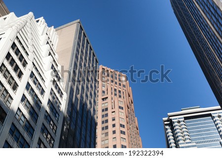 Details of modern city architecture sit against a bright blue sky in the city's financial district.  Photo taken April 6, 2014.