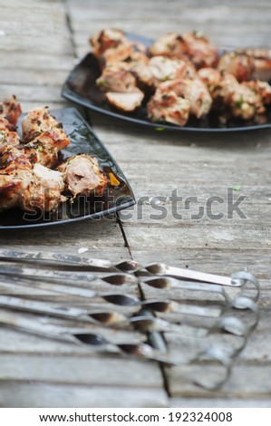 grilled meat  on black plate over wooden table