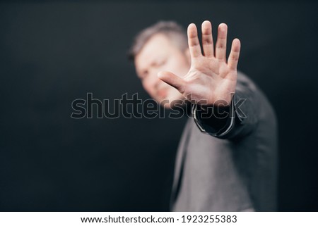 Business man making stop sign, open hand, making five hand gesture. Warning expression with negative and serious gesture on the face