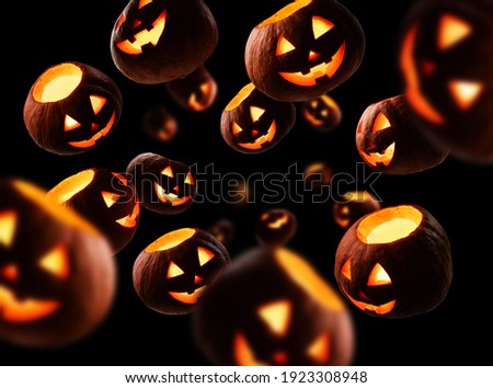 Glowing pumpkins levitate on a black background Royalty-Free Stock Photo #1923308948