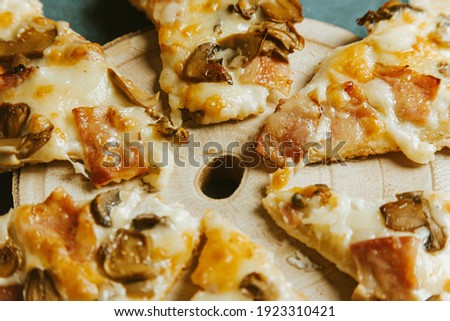 A composite shot of some pizza portions over a wooden table