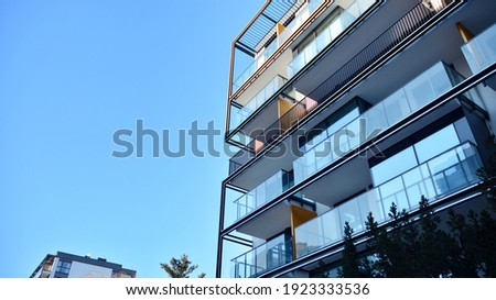 Condominium and apartment building with  symmetrical modern architecture in the city downtown. Royalty-Free Stock Photo #1923333536