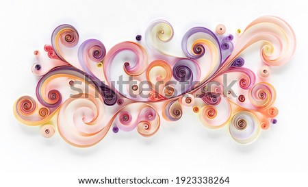 Abstract panel made of colored paper scrolled into curls and rolls. Quilling banner on a white background with copy space. Quilling paper art as a hobby. Royalty-Free Stock Photo #1923338264