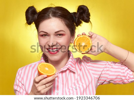 A girl over 30, on a yellow background with an orange, bright and beautiful. The yellow background color easily changes to another one.