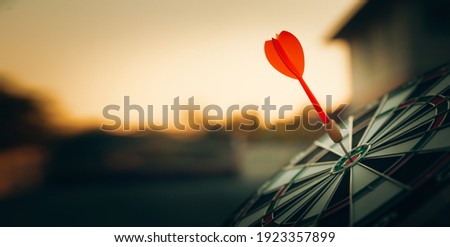bullseye target or dart board has red dart arrow throw hitting the center of a shooting for business targeting and winning goals business concepts. Royalty-Free Stock Photo #1923357899