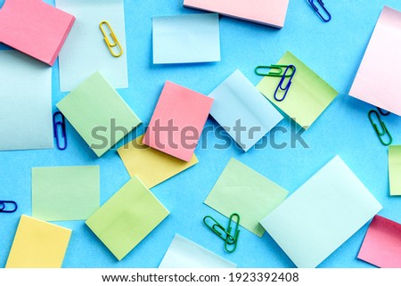 Top view of an office desk with stationery. Stickers on a blue background
