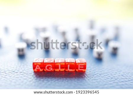 agile written on red cubes in letters, the background cubes are blurred out of focus
