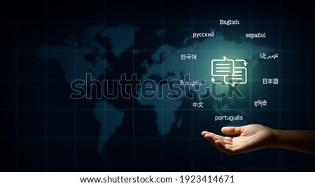 Hand holding speech bubble with arrows and text in many important languages. Illustration of World map background. Translator and languages education concept.