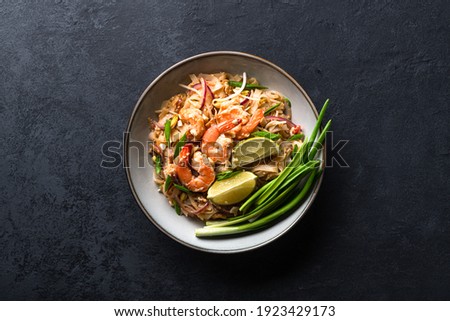 Pad Thai with shrimp and vegetables on a dark background, view from above Royalty-Free Stock Photo #1923429173