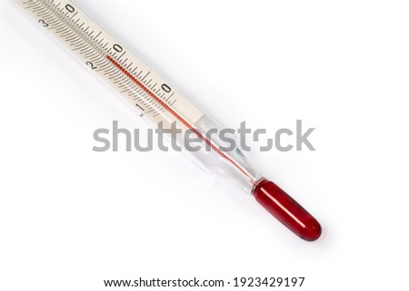 Bottom part of laboratory alcohol glass thermometer with Celsius units scale on a white background close-up, bulb of ethanol with red dye on a foreground 
 Royalty-Free Stock Photo #1923429197