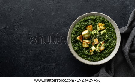 Palak Paneer indian traditional food on black background, top view, copy space Royalty-Free Stock Photo #1923429458