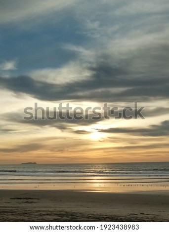 Golden sky and blue clouds over the ocean