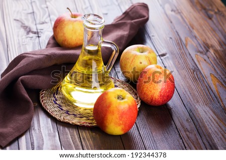 Apple vinegar and apples on  wooden table. Selective focus, horizontal. Royalty-Free Stock Photo #192344378