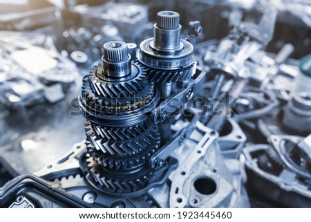 Closeup disassembled car automatic transmission gear part on workbench at garage or repair factory station for fix service or maintenance. Vehicle part detail. Complex industrial mechanism background Royalty-Free Stock Photo #1923445460
