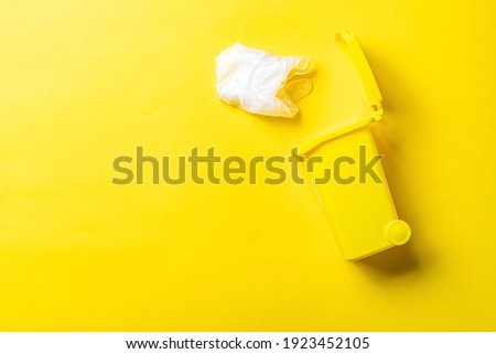 Trash recycle. Bin container for disposal garbage waste and save environment. Yellow dustbin for recycle plastic trash isolated on yellow background