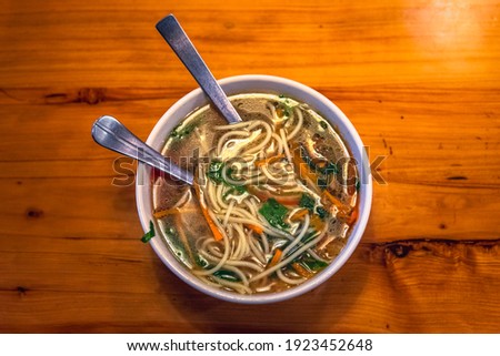 Selective focus of Thukpa, It is a Tibetan noodle soup, which originated in the eastern part of Tibet. Vegetable vegetarian is a famous variant among tourist in Mcleodganj, Himachal Pradesh India. Royalty-Free Stock Photo #1923452648