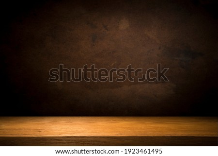 Selected focus empty brown wooden table and wall texture or old black brick wall blur background image. for your photomontage or product display Royalty-Free Stock Photo #1923461495