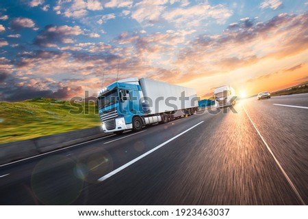 Truck with container on highway, cargo transportation concept. Shaving effect. Royalty-Free Stock Photo #1923463037