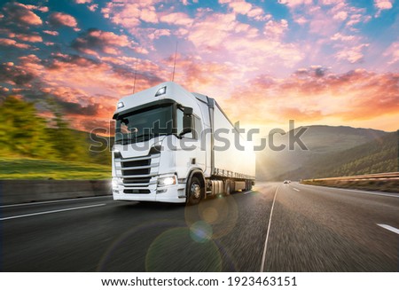 Truck with container on highway, cargo transportation concept. Shaving effect. Royalty-Free Stock Photo #1923463151