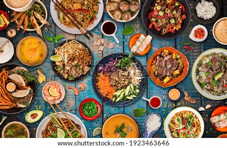 Various of asian meals on rustic background , top view , place for text. Asian food concept. Royalty-Free Stock Photo #1923463646