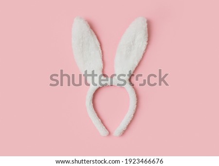 Easter mock up with ears rabbit on pink background, copy space, flat lay, top view