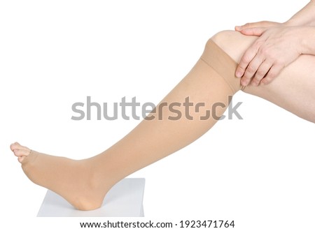Compression garments for the treatment of lipoedema and lymphoedema.Lymphedema management: Wrapping leg using multilayer bandages to control Lymphedema. Part of complete decongestive therapy (cdt Royalty-Free Stock Photo #1923471764