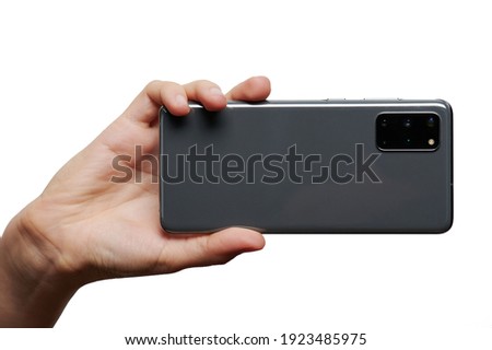 Taking photo with samrtphone in hand isolated on white studio background