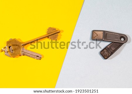 Bunch of Traditional Metal House Keys Against Pair of Electronic Chip Keys  Together Over Colorful Background. Horizontal Image Orientation