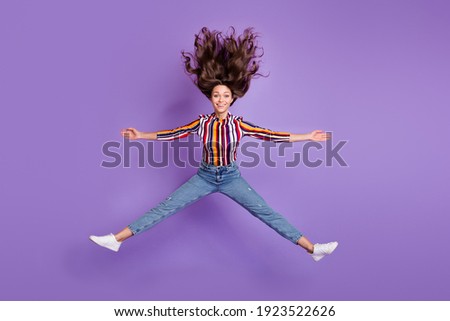 Full length body size photo of woman jumping up embracing happy overjoyed isolated bright violet color background