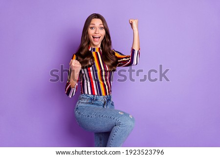 Photo portrait of happy woman gesturing like winner overjoyed isolated vivid purple color background