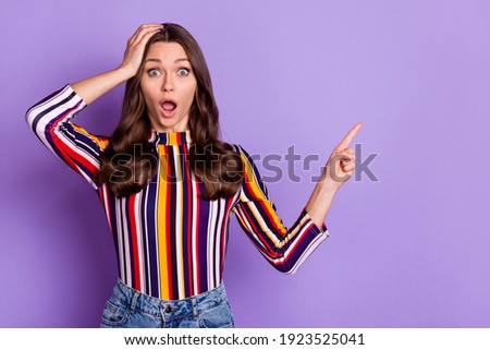 Photo portrait of woman pointing fingers blank space amazed touching head shocked isolated vibrant violet color background