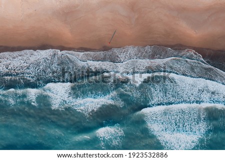 aerial waves and sunset light view of the touristic coastline