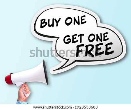 shouting BUY ONE GET ONE FREE using bullhorn, BOGO discount concept Royalty-Free Stock Photo #1923538688