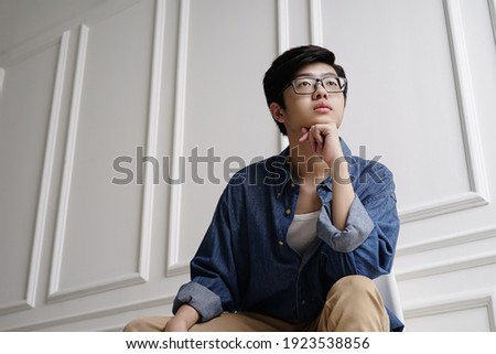 Male Asian Teen thinking and reading