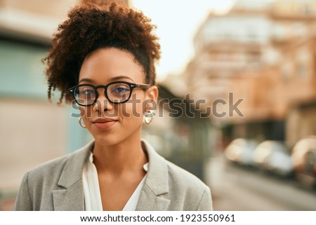 Young african american businesswoman smiling happy standing at the city. Royalty-Free Stock Photo #1923550961