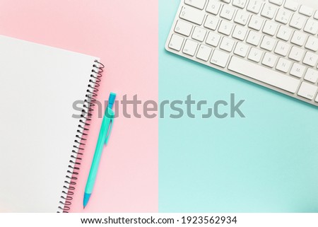 Workspace with notebook, pen and keyboard