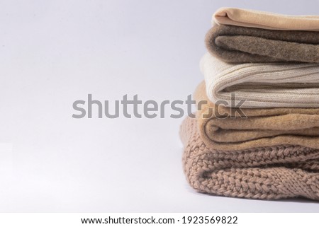 knitted sweater stack for cold autumn weather with copy space 