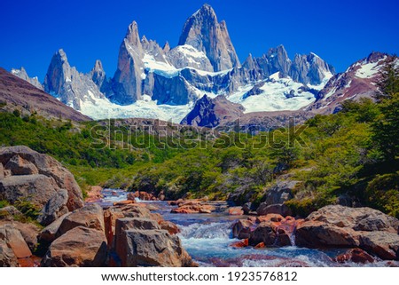 A unique and beautiful scenery: a blue river in El Chaltén, Patagonia, and Mount Fitz Roy in the background. Located at the Southern Patagonic Andes between Chile and Argentina.  Royalty-Free Stock Photo #1923576812